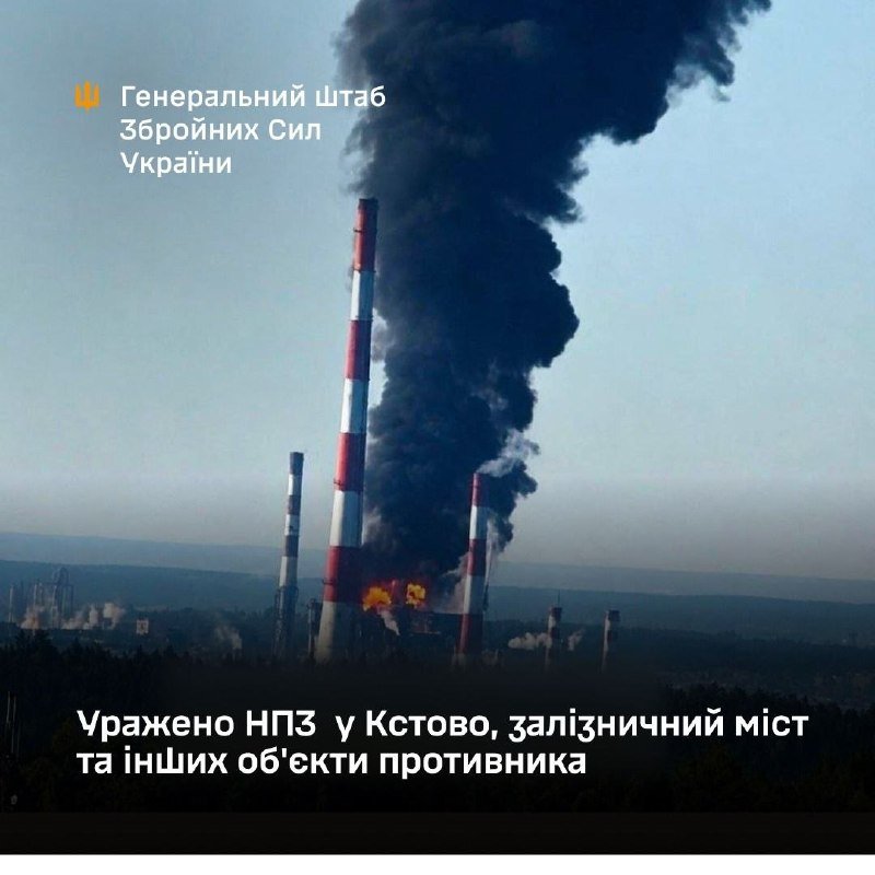 Satellite image showing an industrial facility with red redaction blocks, watermarked with Arabic text and a NASA logo, and a 2 km scale bar.