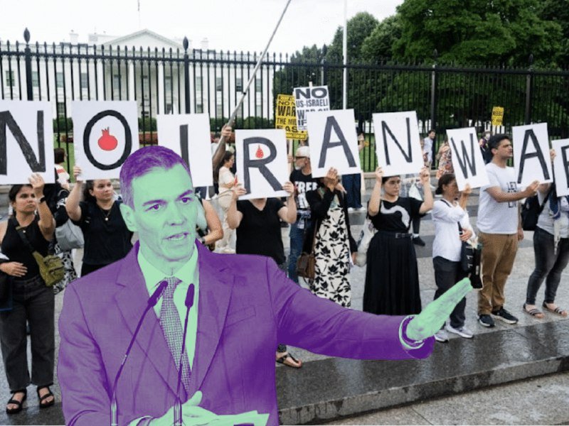 A green-tinted cutout of a man speaking at a podium is held in front of demonstrators holding "NO TO IRAN WAR" signs outside a gated white building.