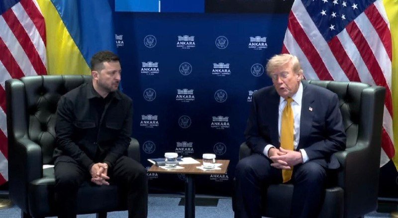 Two men in suits sit in green armchairs facing each other before a backdrop reading "ANKARA," flanked by Ukrainian and American flags.