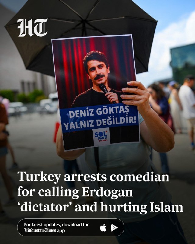 A uniformed security officer stands guard in front of a large blue billboard promoting the "NATO Ankara Summit: A Shared Future in Peace."