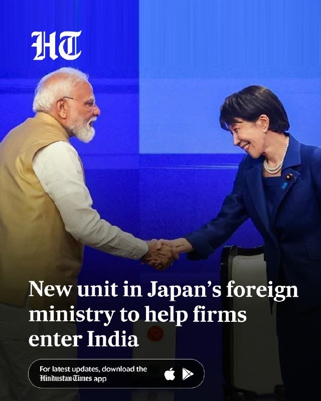 A bearded man in a yellow vest shakes hands and smiles with a woman in a blue suit against a blue background, with the Hindustan Times logo visible.
