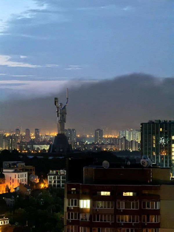 A graphic illustration showing thick black smoke rising near buildings, overlaid with repeating "INFO Київ INFO" text and Telegram channel logos.