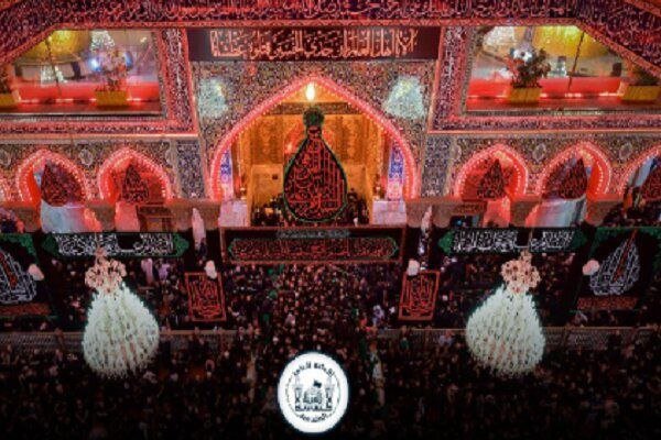 Iran flag-draped coffin carried over a dense crowd under red lighting at a nighttime ceremony.