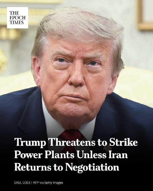 A man with blonde hair wearing a dark suit and red tie sits in front of a cream-colored chair, with a headline reading "Trump Threatens to Strike Power Plants Unless Iran Returns to Negotiation" displayed below.
