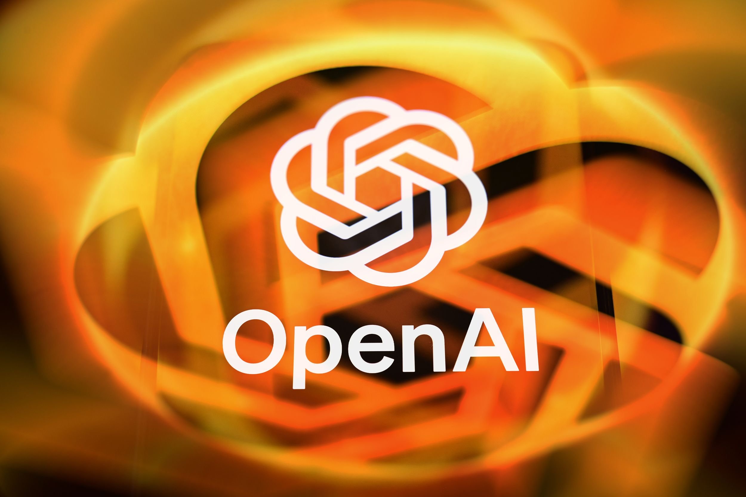The OpenAI logo and wordmark appear over a swirling orange and yellow abstract background.