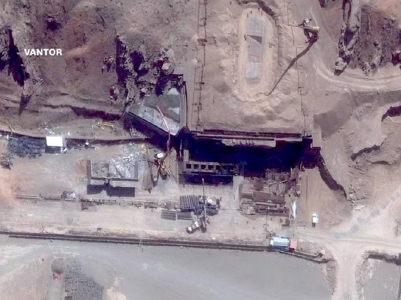 A satellite image labeled "VANTOR" shows an industrial site with buried structures, excavation areas, and scattered vehicles in an arid, mountainous landscape.