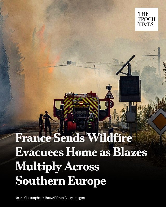 A digital news graphic from The Epoch Times featuring a photograph of firefighters and civilians gathered near a red fire truck on a smoke-filled road, with flames visible in the background.