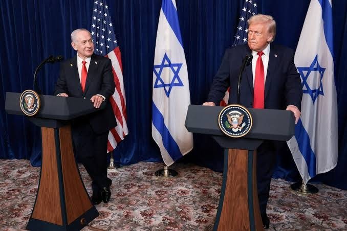 A split-frame photograph shows, on the left, a bearded man wearing a red-and-white keffiyeh and black agal, and on the right, a gray-haired man in a dark suit and blue tie, both smiling slightly.