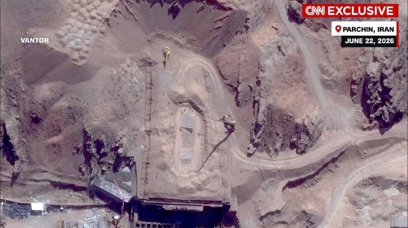 Satellite image labeled "VANTOR" shows a large industrial excavation site with underground structures, adjacent buildings, and vehicles in an arid landscape.