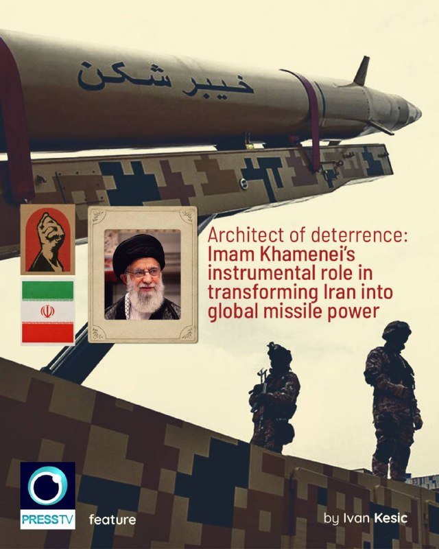 A bearded man in a white turban and brown robe sits with clasped hands beside the Iranian flag and a blue flag with scales-of-justice imagery.