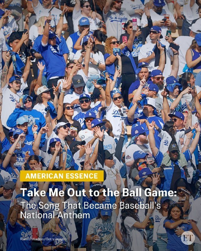 A large crowd of fans wearing blue and white Dodgers apparel cheers with raised hands in stadium seating.