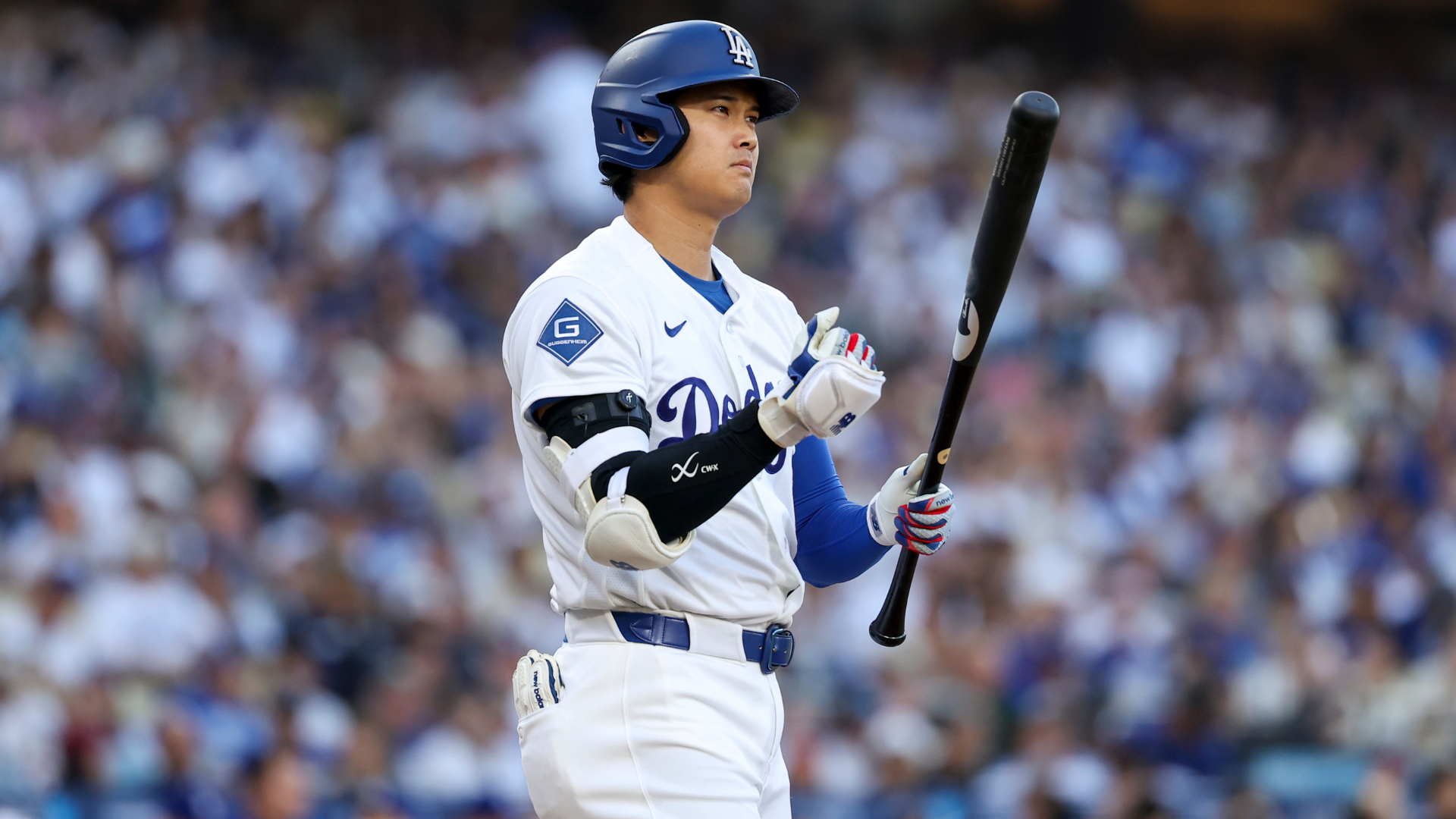 The Dodgers' two-way star will sit out Tuesday's showcase in Arlington after his left knee flared up again, leaving Los Angeles to manage the most valuable player in baseball through the second half.