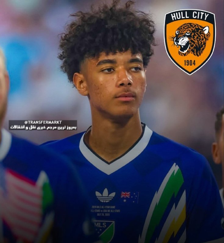 A young soccer player with curly hair wears a blue MLS All-Star jersey, with a Hull City 1904 tiger crest displayed in the corner.