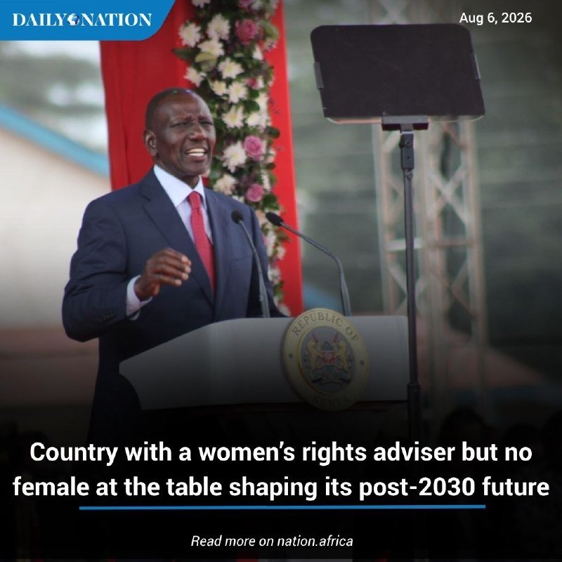 A man in a dark suit and red tie speaks at a podium bearing a "Republic of Kenya" seal, with a floral arrangement and red banner behind him.