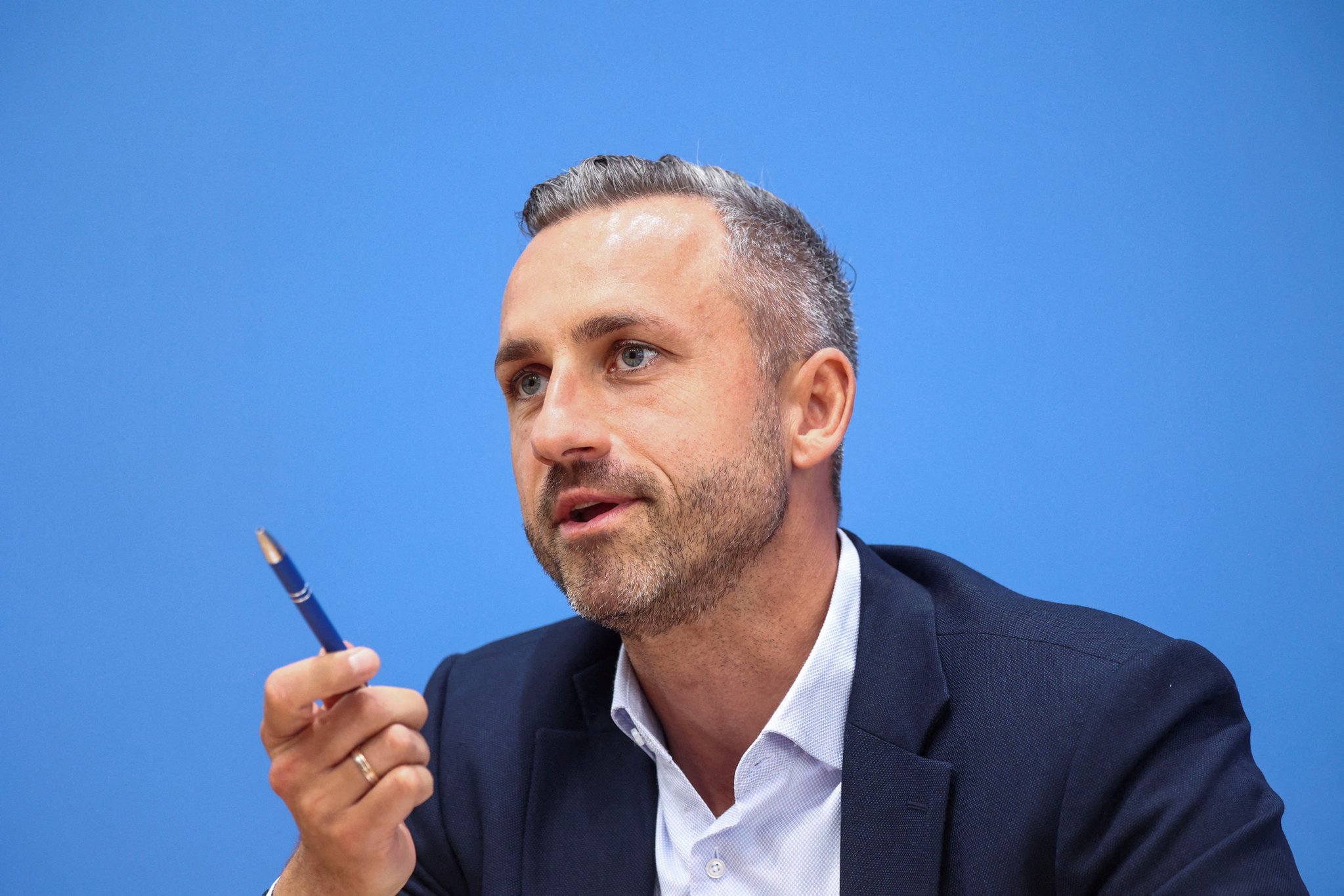 A near-doubling of conscientious-objection filings in Germany collides with a record June heat toll and a budget-tested Zeitenwende, exposing the political limits of European rearmament.