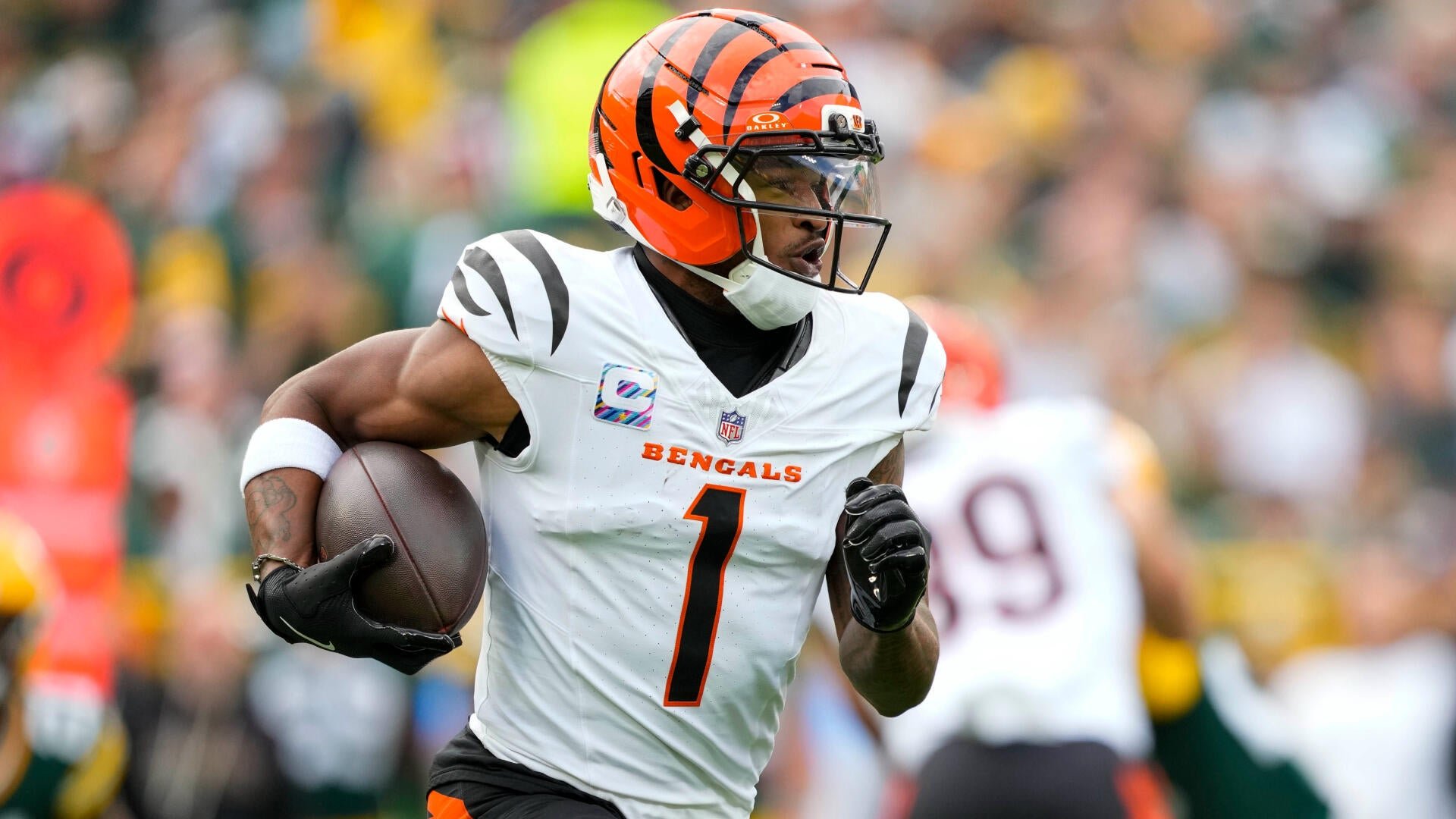 A Cincinnati Bengals football player wearing jersey number 1 runs with the ball during an NFL game.