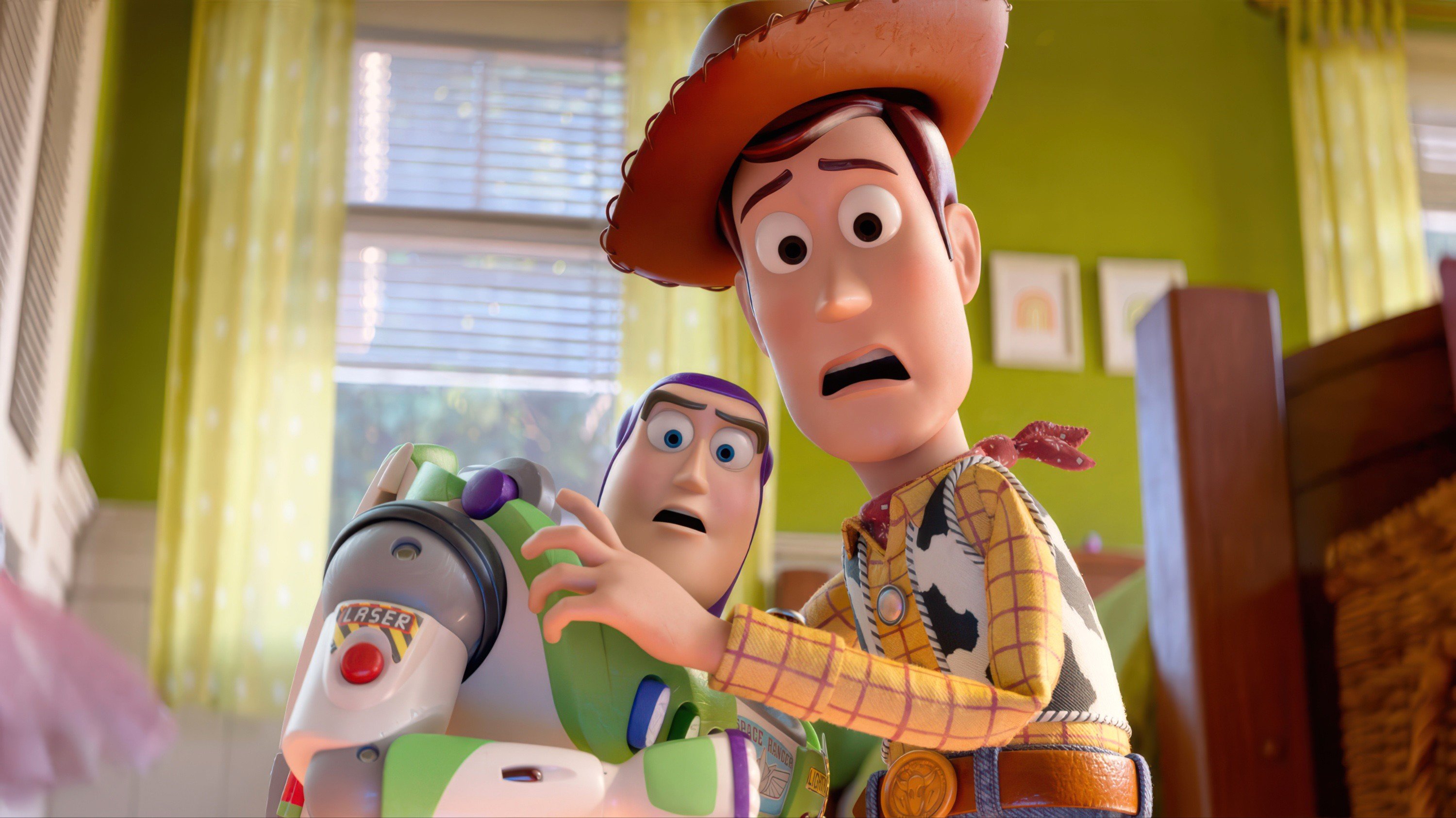 In this computer-generated image, two animated toys—a cowboy and a space ranger—stand in a child's bedroom, holding a green laser-equipped toy with concerned expressions.