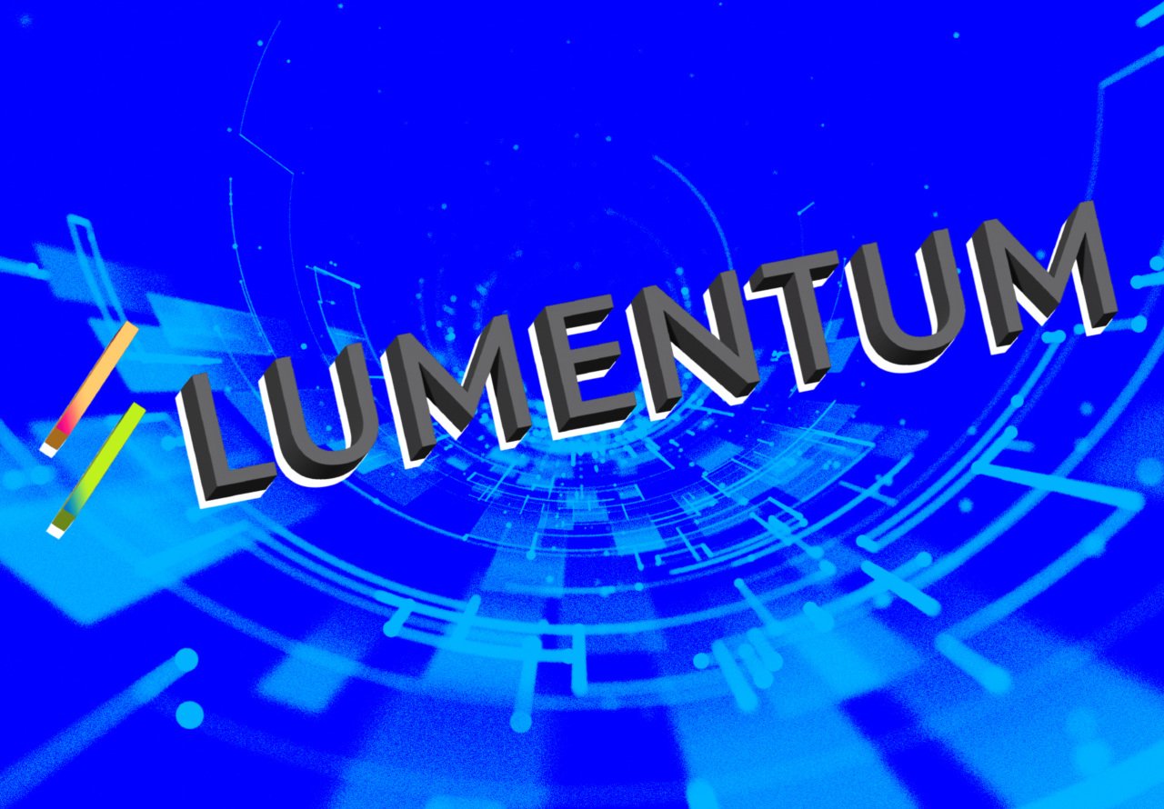 A digital graphic displays the word "LUMENTUM" in bold 3D lettering against a blue background with abstract circular tech patterns.