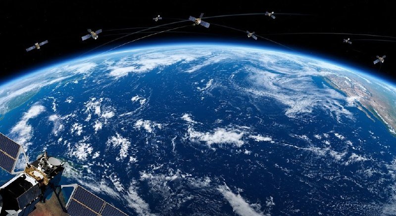 A satellite with solar panels orbits Earth, depicted alongside several satellites connected by trajectory lines in this illustration showing the planet's cloud-covered surface.