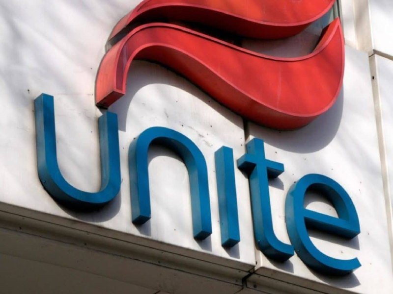 A storefront sign displays the word "unite" in blue letters beneath a red wave-like logo.