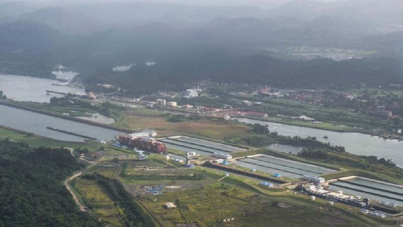 Containerships in the Panama Canal's lock chamber during a prior low-water period, the kind of bottleneck the Authority's tighter transit ceiling from 3 September is meant to pre-empt.