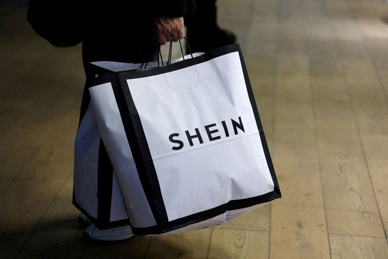 Shein's red-bag branding on a Hong Kong trading screen at the open of bookbuilding.