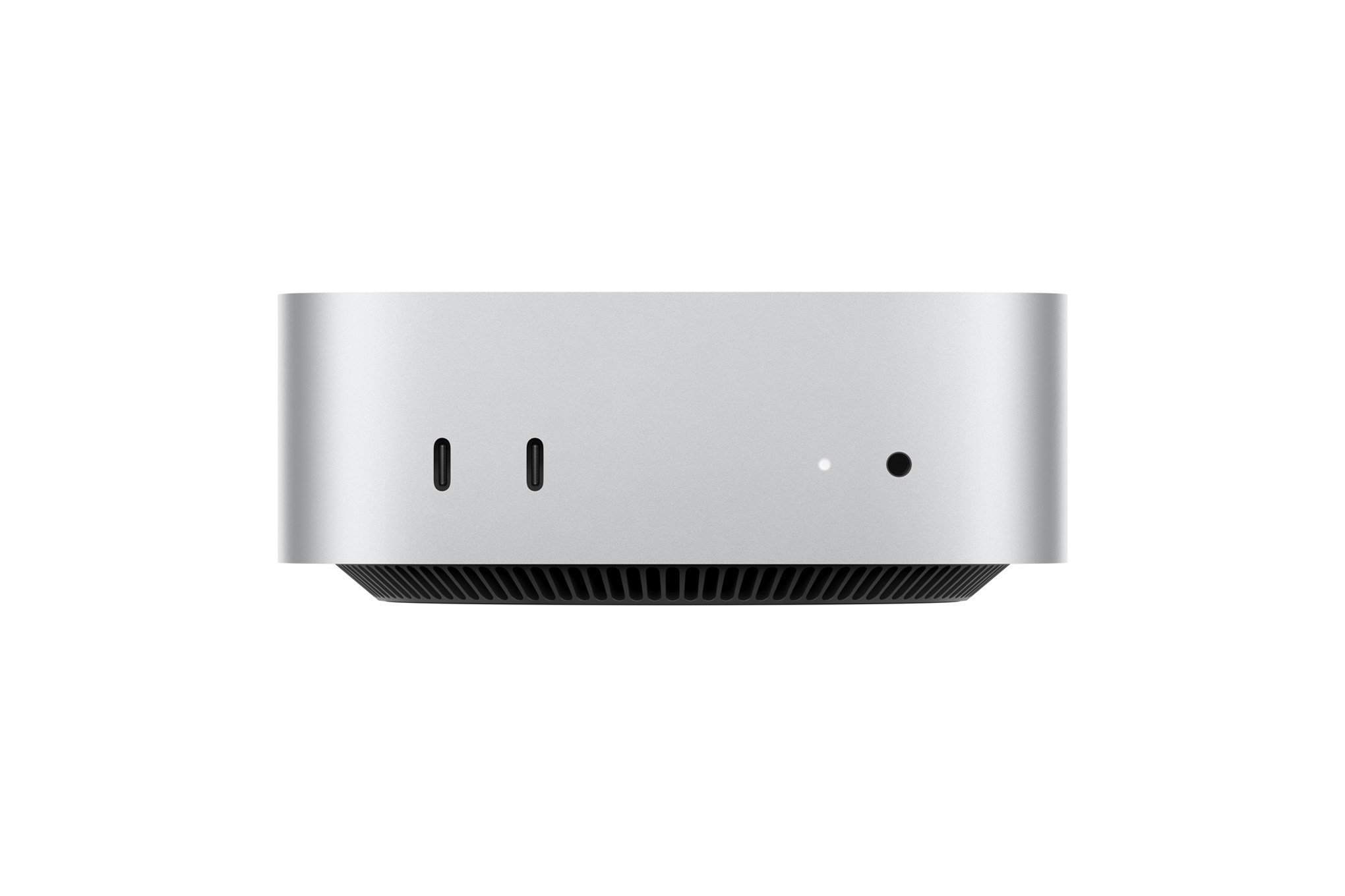 A silver, cube-shaped compact computer with rounded edges, displaying two USB-C ports, a small LED indicator, and an audio jack on its front, with a black vented base.