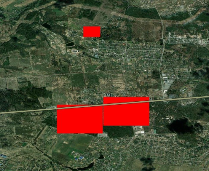 Satellite image showing a landscape of forests, fields, roads, and scattered buildings overlaid with three solid red rectangles of varying sizes.