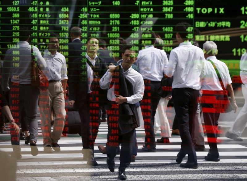A trading screen displays red across Asian indices as the Tokyo open followed a steep overnight Wall Street decline.